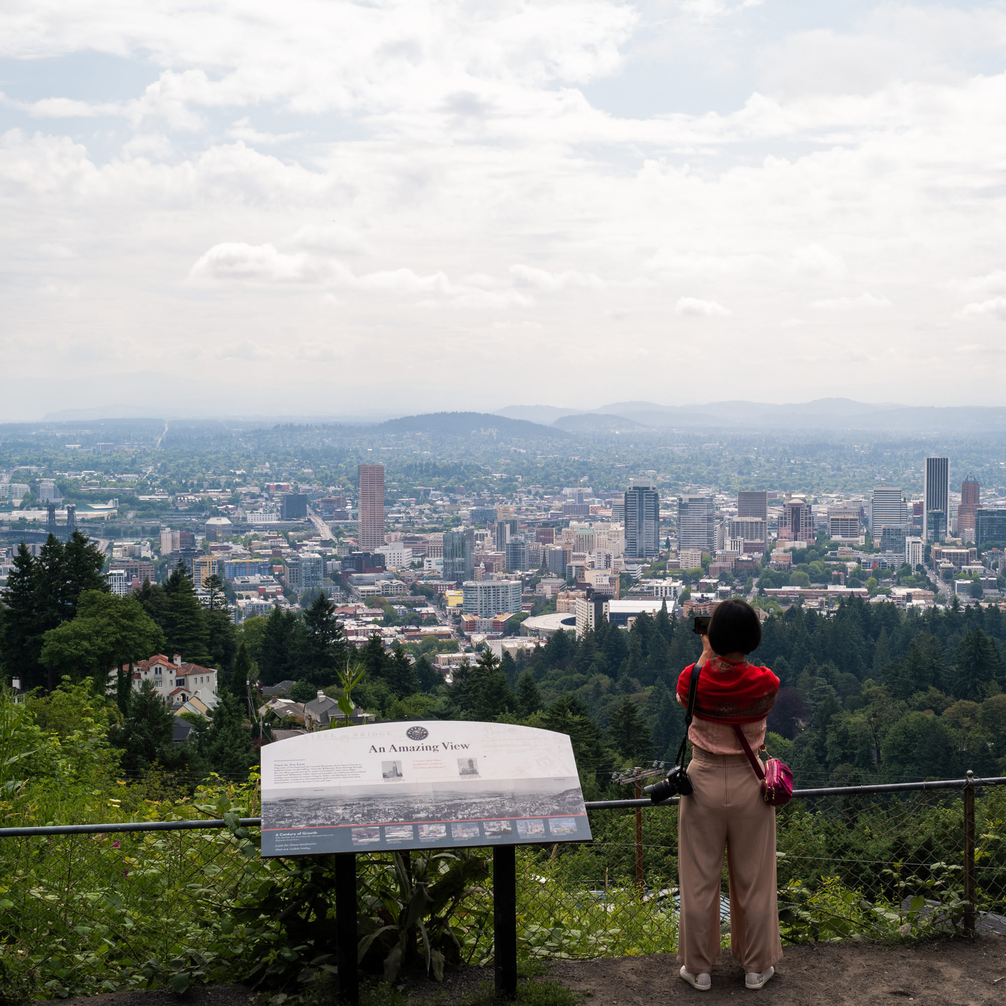 woman photographing view of portland